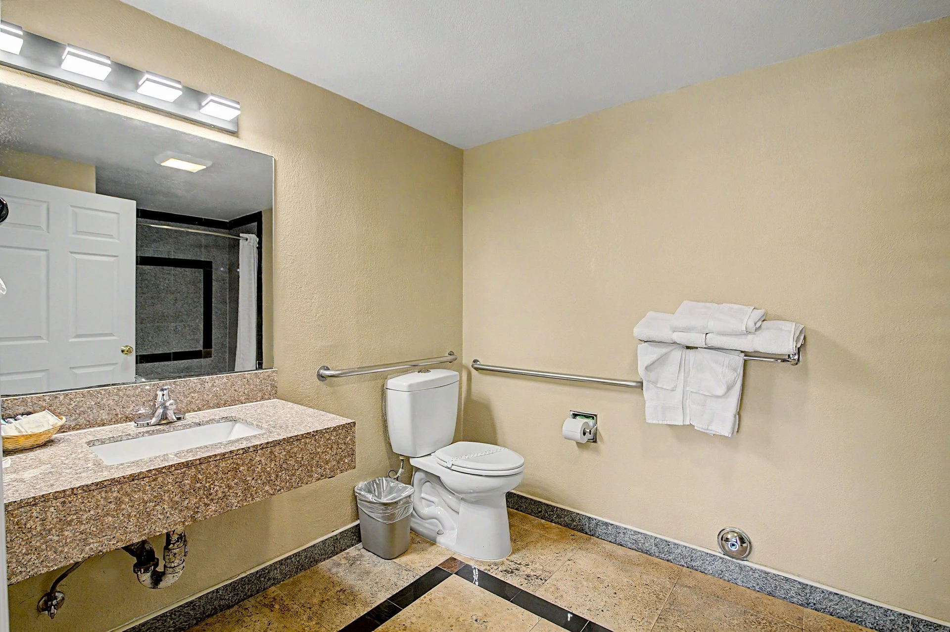 One Queen ADA Bathroom with roll-in shower amenities